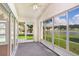 Enclosed lanai with lake view and sliding windows for natural lighting at 4407 Whitton Way, New Port Richey, FL 34653