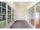 Enclosed lanai offering a view of the lake from wall to wall glass windows at 4407 Whitton Way, New Port Richey, FL 34653