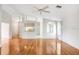 Spacious living room with hardwood floors, ceiling fan, and access to kitchen at 4407 Whitton Way, New Port Richey, FL 34653