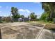 Spacious backyard featuring a large concrete slab, a shed, and a chain-link fence at 4535 15Th S Ave, St Petersburg, FL 33711