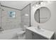 Bathroom with white tile walls, a shower-tub combo, modern vanity, and neutral-toned walls at 4535 15Th S Ave, St Petersburg, FL 33711