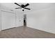 Bedroom with a ceiling fan, closet, and doorway, tile floors and white walls at 4535 15Th S Ave, St Petersburg, FL 33711