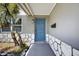 Close-up showcasing the home's entrance, highlighting the blue front door and stylish stone accent wall at 4535 15Th S Ave, St Petersburg, FL 33711