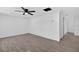 Spacious living room featuring modern flooring, a ceiling fan, neutral paint, and ample natural light at 4535 15Th S Ave, St Petersburg, FL 33711