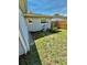 This backyard features a small lawn, a wooden fence, and a ladder against the house at 5215 76Th N N St, St Petersburg, FL 33709