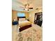 Bedroom featuring a bed, ceiling fan, and closet; natural light and decorative rug enhance the space at 5215 76Th N N St, St Petersburg, FL 33709
