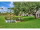 Tranquil backyard featuring a picturesque pond and lush greenery at 5502 Carrollwood Key Dr, Tampa, FL 33624
