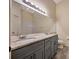 Bathroom with a dual sink vanity, granite countertops, and a walk-in shower at 5502 Carrollwood Key Dr, Tampa, FL 33624