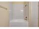 Bright bathroom featuring a white tiled shower and bronze fixtures at 5502 Carrollwood Key Dr, Tampa, FL 33624