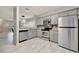 Modern kitchen featuring stainless steel appliances, gray cabinets and granite countertops at 5502 Carrollwood Key Dr, Tampa, FL 33624