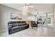 Bright, open living space with modern tile flooring, sleek furniture, and an adjacent dining area at 5502 Carrollwood Key Dr, Tampa, FL 33624