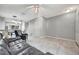 Spacious living room featuring sleek tile flooring, neutral walls, and a view of the dining area at 5502 Carrollwood Key Dr, Tampa, FL 33624