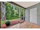Enclosed screened patio with tile flooring and views of the lush backyard at 5502 Carrollwood Key Dr, Tampa, FL 33624