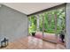 Screened in patio with tiled flooring and a beautiful view of the backyard at 5502 Carrollwood Key Dr, Tampa, FL 33624
