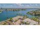 Stunning aerial view of a waterfront property with a dock, pool, and lush landscaping at 5950 Bikini N Way, St Pete Beach, FL 33706