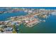 Expansive aerial view of waterfront homes, palm trees and calm waters in a coastal community at 5950 Bikini N Way, St Pete Beach, FL 33706