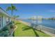 Spacious backyard with lush lawn and waterfront views, perfect for outdoor living at 5950 Bikini N Way, St Pete Beach, FL 33706