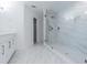 Updated bathroom features a glass-enclosed shower with marble-look tile and vanity at 5950 Bikini N Way, St Pete Beach, FL 33706