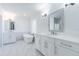 Bright, all-white bathroom features a soaking tub, dual vanities, and a large mirror at 5950 Bikini N Way, St Pete Beach, FL 33706