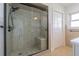 This bathroom features a shower with a glass door, tiled walls, and a tiled floor at 5950 Bikini N Way, St Pete Beach, FL 33706