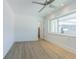 This bedroom features a ceiling fan, a window, and luxury vinyl plank flooring at 5950 Bikini N Way, St Pete Beach, FL 33706