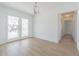 Bright, modern dining room featuring wood floors, textured ceiling, and elegant glass doors to the outside at 5950 Bikini N Way, St Pete Beach, FL 33706