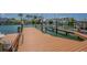 A wooden dock with boat lift provides easy access to open water for boating and fishing at 5950 Bikini N Way, St Pete Beach, FL 33706