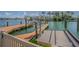 Waterfront property featuring a private dock with boat lift, perfect for boating enthusiasts at 5950 Bikini N Way, St Pete Beach, FL 33706