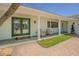 Inviting covered porch with white columns, double doors, and brick walkway, perfect for relaxing at 5950 Bikini N Way, St Pete Beach, FL 33706