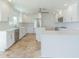 Bright, modern kitchen with white cabinets, quartz countertops, stainless steel appliances, and a center island at 5950 Bikini N Way, St Pete Beach, FL 33706