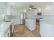 Bright, updated kitchen with stainless steel appliances, tile flooring, and white cabinetry at 5950 Bikini N Way, St Pete Beach, FL 33706
