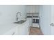 This laundry room features a washing machine, a dryer, a sink, and cabinetry at 5950 Bikini N Way, St Pete Beach, FL 33706