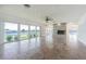 Spacious living room with a brick fireplace and scenic water views from the many large windows at 5950 Bikini N Way, St Pete Beach, FL 33706