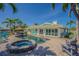 Outdoor living space with a pool, spa, and lounge chairs, perfect for relaxation at 5950 Bikini N Way, St Pete Beach, FL 33706