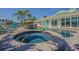 Private outdoor oasis featuring pool, spa, and covered patio for luxurious waterfront living at 5950 Bikini N Way, St Pete Beach, FL 33706