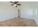 Bright living area with laminate wood flooring, ceiling fan, and neutral walls at 5950 Bikini N Way, St Pete Beach, FL 33706