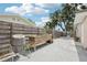 Private fenced-in backyard featuring a raised garden bed and sunny patio area at 6220 Murdock Ave, Sarasota, FL 34231