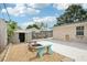 Backyard featuring a fire pit, storage shed, and access to a fenced in patio area at 6220 Murdock Ave, Sarasota, FL 34231
