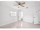 Bright bedroom features a ceiling fan and two doorways, one of which leads to an ensuite bathroom at 6220 Murdock Ave, Sarasota, FL 34231