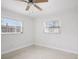 Bright bedroom with two windows providing plenty of natural light and a ceiling fan for added comfort at 6220 Murdock Ave, Sarasota, FL 34231