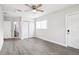 This cozy bedroom features wood-look flooring, a ceiling fan, and bathroom access at 6220 Murdock Ave, Sarasota, FL 34231