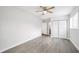A spacious bedroom features wood-look flooring, ceiling fan, and closet for ample storage at 6220 Murdock Ave, Sarasota, FL 34231