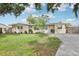Charming single-story home with a well-maintained lawn, inviting curb appeal, and a light blue front door at 6220 Murdock Ave, Sarasota, FL 34231
