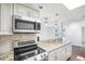 Kitchen with stainless steel appliances, tile backsplash, and granite countertops at 6220 Murdock Ave, Sarasota, FL 34231
