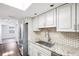 Updated kitchen featuring white cabinets, granite counters and stainless appliances at 6220 Murdock Ave, Sarasota, FL 34231