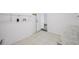 Bright laundry room featuring tile flooring, washer/dryer hookups, and convenient access to the rest of the home at 6220 Murdock Ave, Sarasota, FL 34231