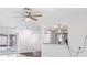 Open-concept living area with stylish lighting, a glimpse into the kitchen, and sliding doors to the lanai at 6220 Murdock Ave, Sarasota, FL 34231