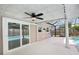 Covered patio with sliding glass door, ceiling fan, and view of screened-in pool area at 6220 Murdock Ave, Sarasota, FL 34231