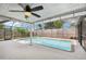 Covered pool area with screened enclosure, fan, and string lights at 6220 Murdock Ave, Sarasota, FL 34231