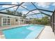 View of screened-in pool area with nice sky, lanai and partial home exterior at 6220 Murdock Ave, Sarasota, FL 34231